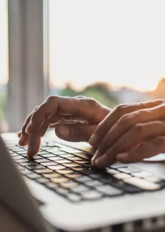 Person typing on laptop